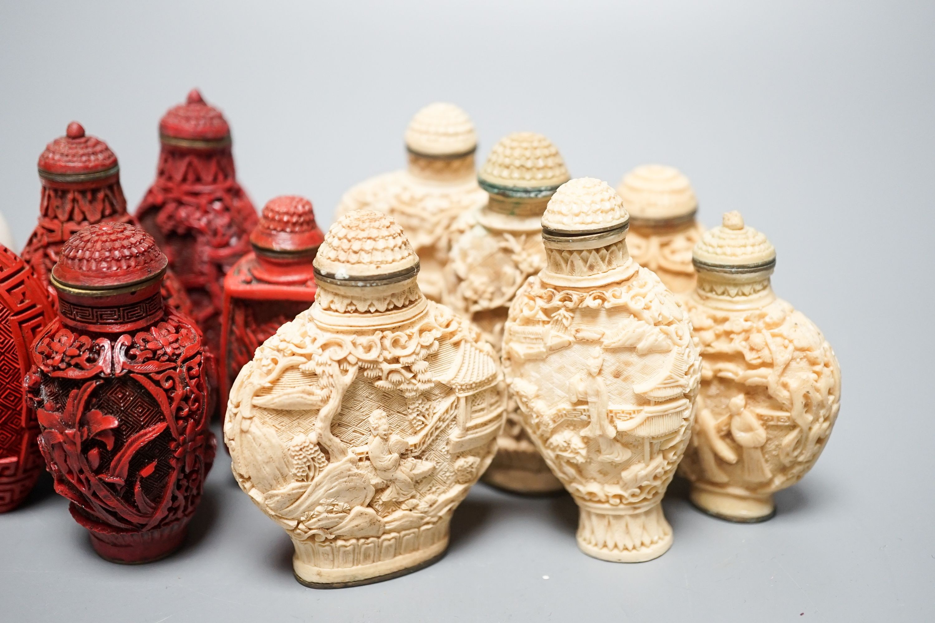 A collection of Chinese snuff bottles, 20th century, including a carved cinnabar lacquer and hardstone inlaid snuff bottle, 7.4cm (23)